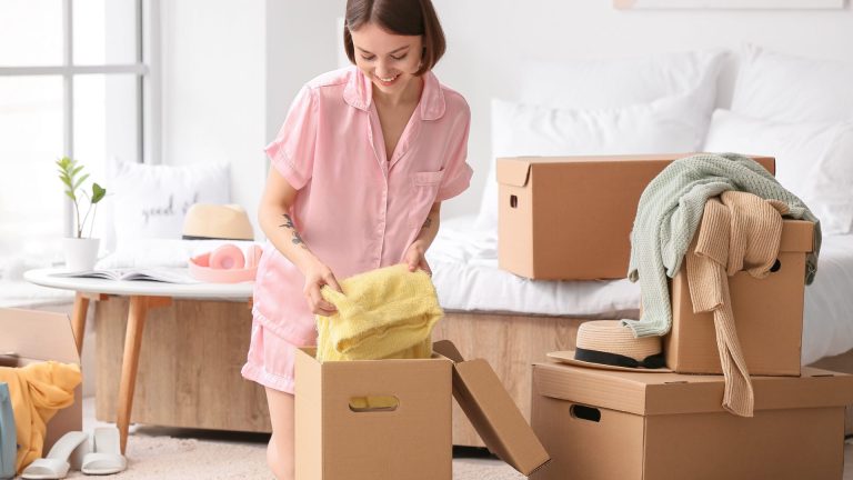 Picture of woman packing clothes into boxes