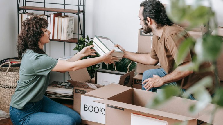 Image of couple packing books into boxes