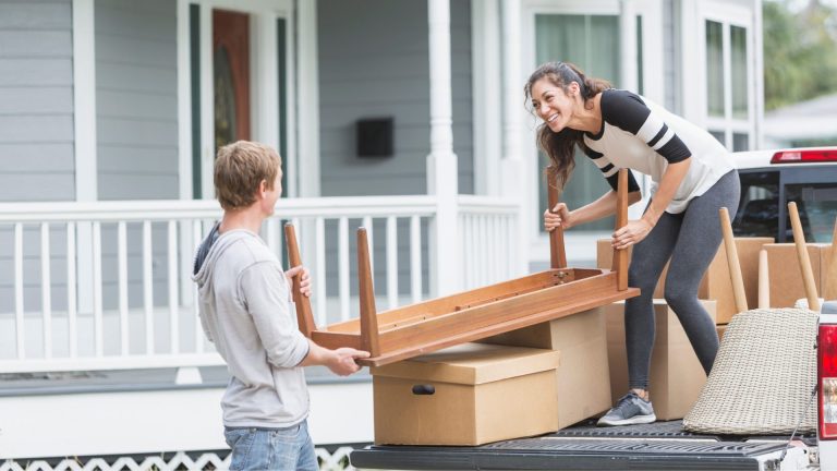 Picture of couple moving outdoor furniture